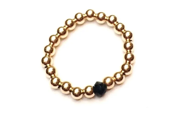 Ring black gold coloured