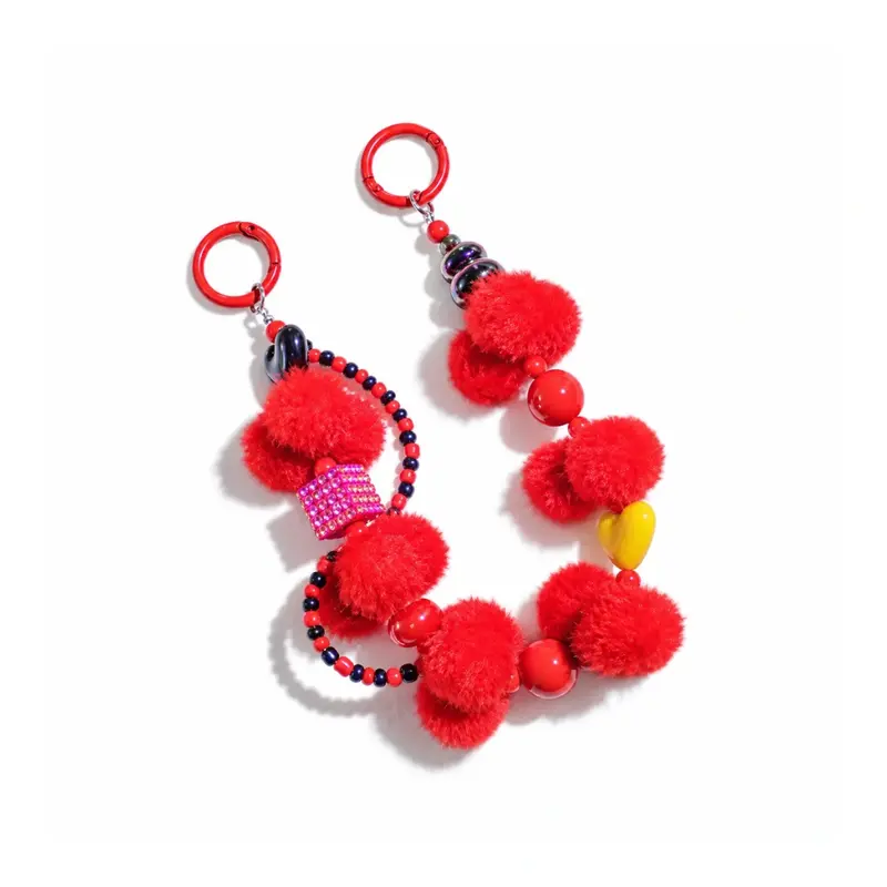 Rode pompom tashanger met chunky kralen